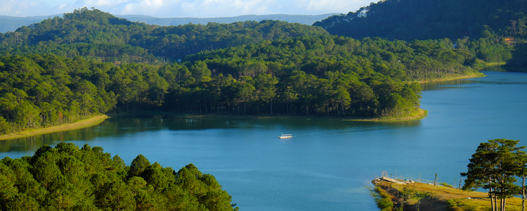 Tuyen Lam lake at Dalat, Vietnam, beautiful landscape for eco travel at Viet Nam, amazing lake among pine forest make wonderful scene, boat on water, Da Lat countryside  is famous place for  holiday