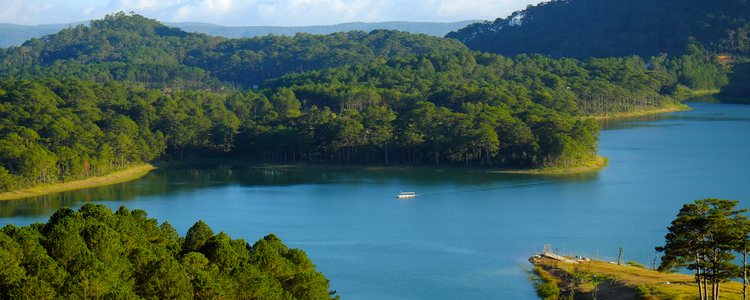 Tuyen Lam lake at Dalat, Vietnam, beautiful landscape for eco travel at Viet Nam, amazing lake among pine forest make wonderful scene, boat on water, Da Lat countryside  is famous place for  holiday