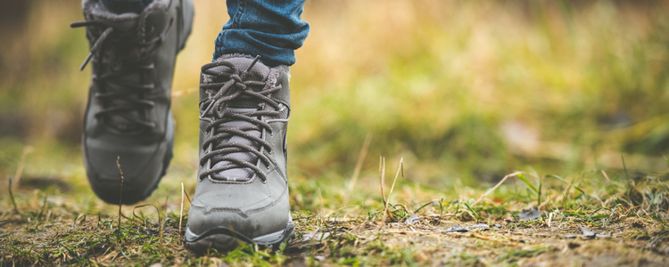 feet in shoes on a forest path