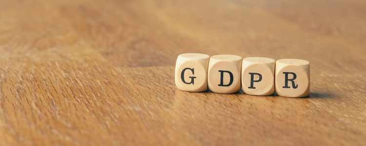 GDPR concept image with small wooden dices on a wooden background